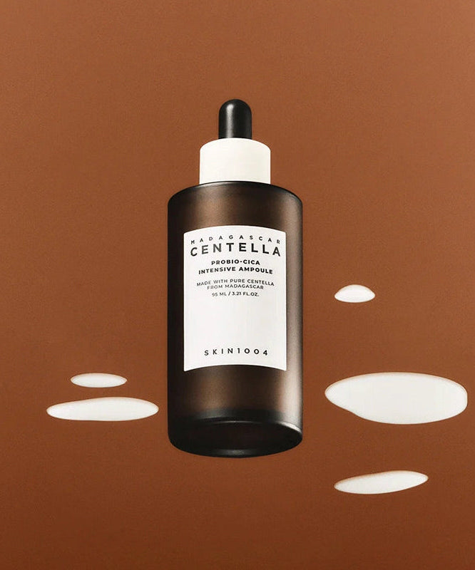SKIN1004 Madagascar Centella Probio-cica Intensive Ampoule 50ml bottle with splashes on a brown background.