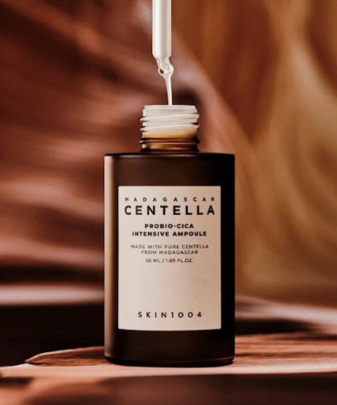 SKIN1004 Madagascar Centella Probio-cica Intensive Ampoule 50ml on wooden surface with dropper above.