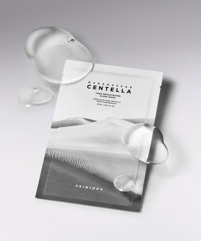 SKIN1004 Madagascar Centella Tone Brightening Glow Mask 25ml [5 sheets] on a sleek background with water droplets
