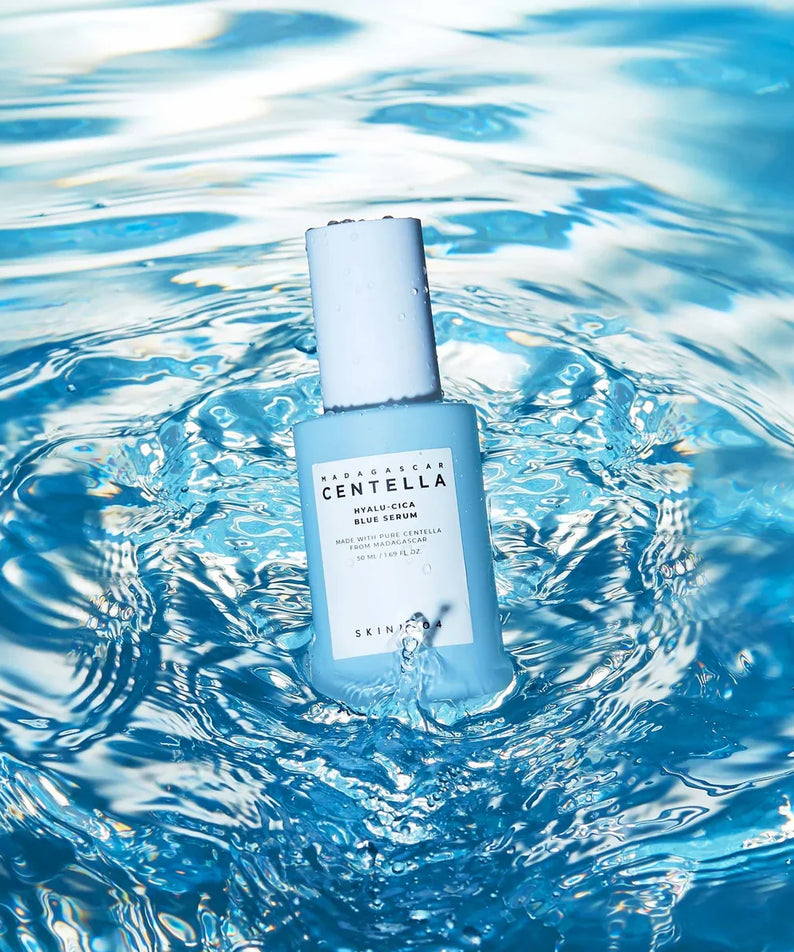 SKIN1004 Madagascar Centella Hyalu-Cica Blue Serum 50ml bottle in a splash of water