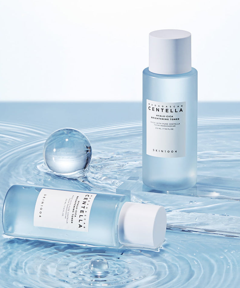 SKIN1004 Madagascar Centella Hyalu-Cica Radiance Toner 210ml bottles on a watery surface.