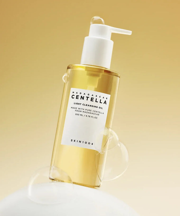 Bottle of SKIN1004 Madagascar Centella Light Cleansing Oil 200ml with bubbles on a neutral background