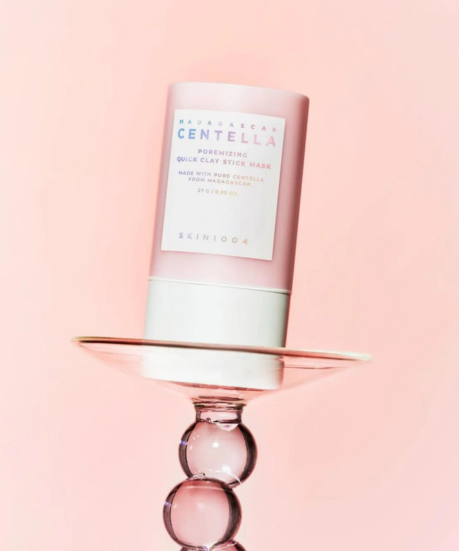 SKIN1004 Madagascar Centella Poremising Quick Clay Stick Mask 27g on display against a pink background