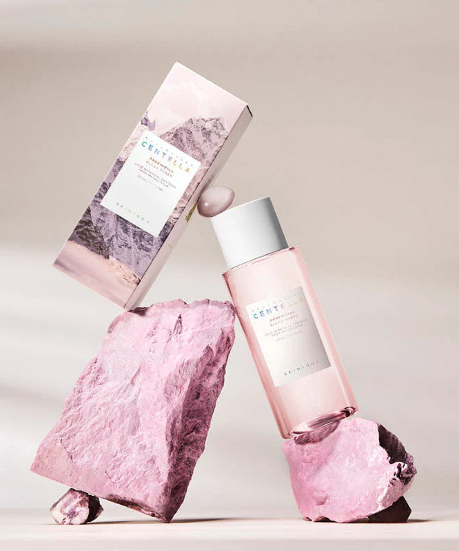 SKIN1004 Madagascar Centella Poremizing Clear Toner 210ml bottle with packaging displayed on pink rocks.