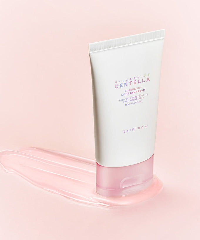SKIN1004 Madagascar Centella Poremizing Light Gel Cream 75ml on a pink background, showcasing the product's sleek packaging.