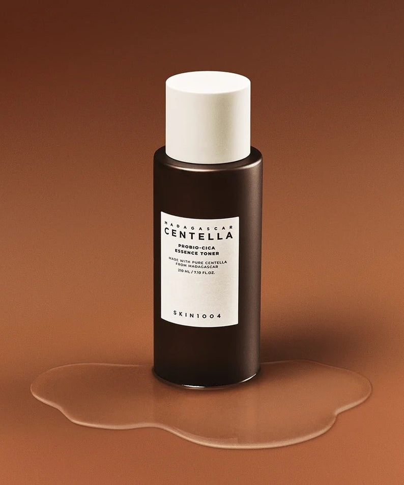 SKIN1004 Madagascar Centella Probio-cica Essence Toner 210ml bottle on a brown background.