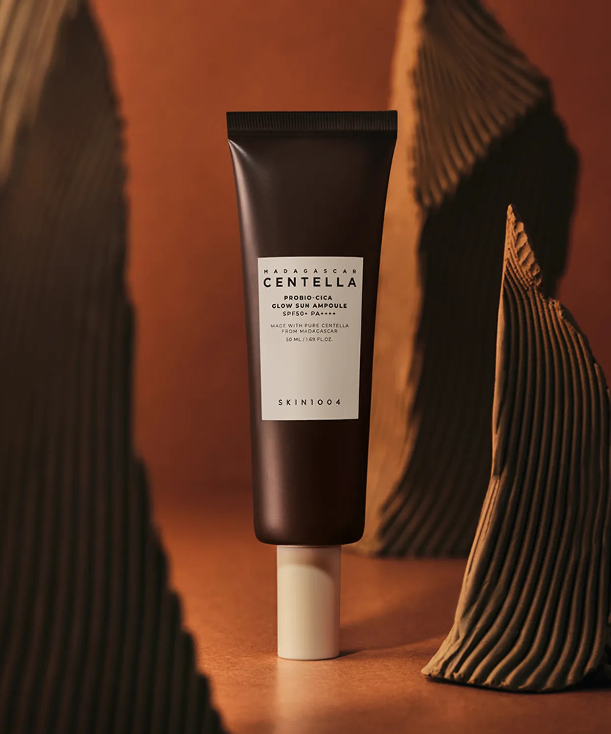 SKIN1004 Madagascar Centella Probio-cica Glow Sun Ampoule 50ml against artistic background