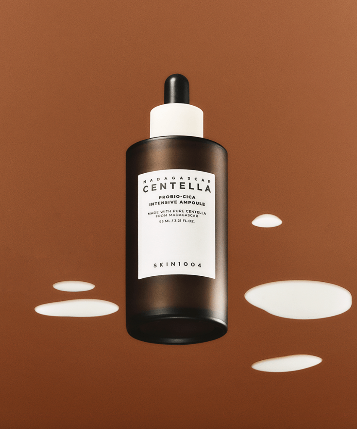 SKIN1004 Madagascar Centella Probio-cica Intensive Ampoule 95ml bottle on brown background with liquid drops