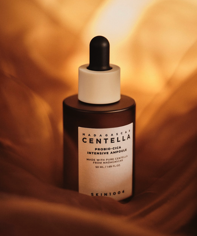 SKIN1004 Madagascar Centella Probio-cica Intensive Ampoule 95ml bottle on a soft brown fabric background.