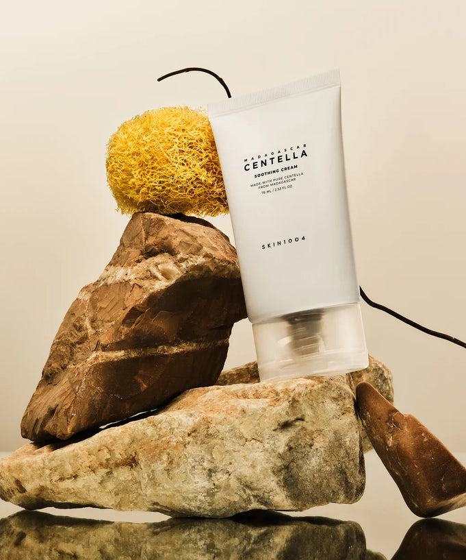 Image of SKIN1004 Madagascar Centella Soothing Cream 75ml tube displayed on natural rocks.