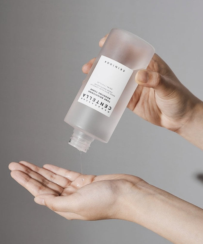 Applying SKIN1004 Madagascar Centella Tone Brightening Boosting Toner 210ml to hands