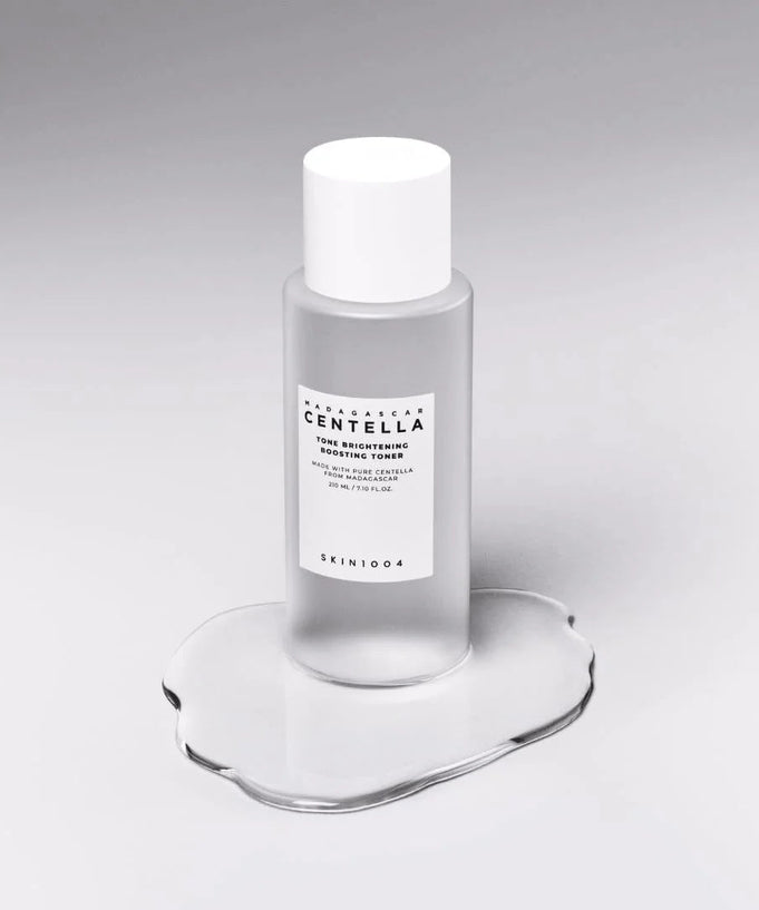 SKIN1004 Madagascar Centella Tone Brightening Boosting Toner 210ml bottle on a reflective surface.