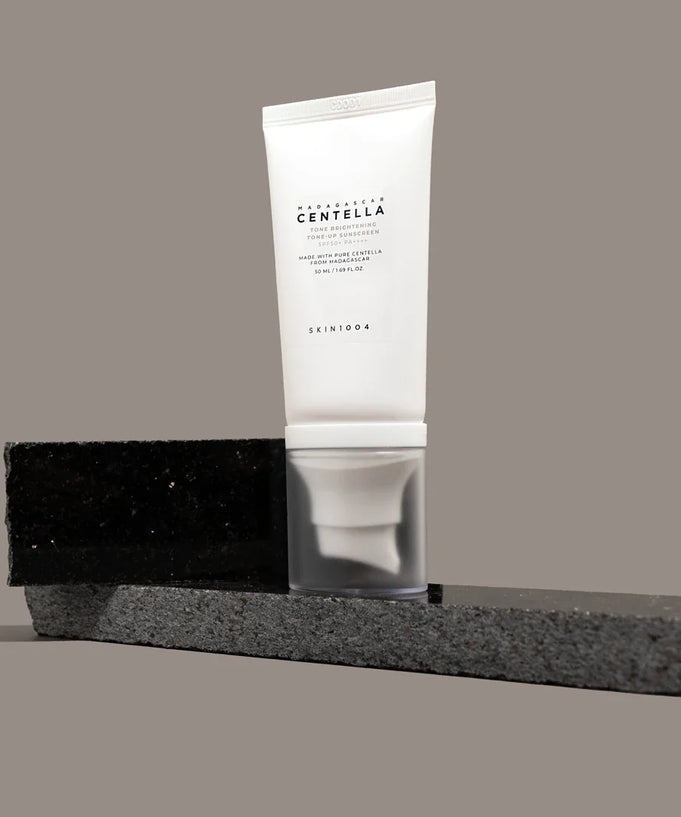 SKIN1004 Madagascar Centella Tone Brightening Tone-Up Sunscreen 50ml product display on modern stone background