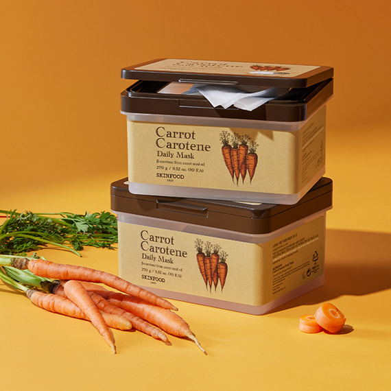 Image of SKINFOOD Carrot Carotene Daily Mask 30p 270g packaging with fresh carrots in the background.