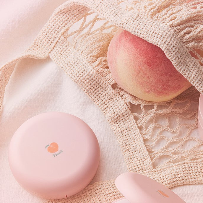 SKINFOOD Peach Cotton Pore Blur Pact 4g with peach in background, highlighting packaging and product texture.