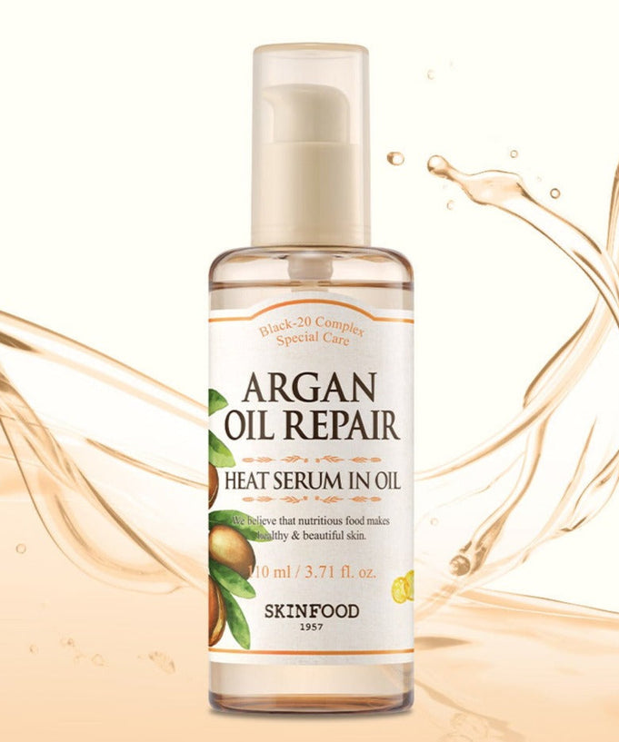 SKINFOOD Argan Oil Repair Heat Serum In Oil 110ml bottle against oil splash background