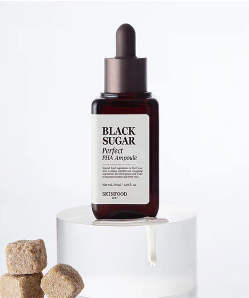 SKINFOOD Black Sugar Perfect PHA Ampoule 50ml bottle with sugar cubes, showcasing the product's exfoliating properties.