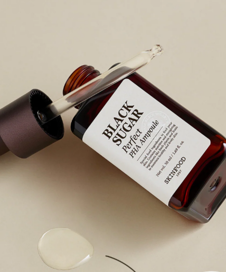 SKINFOOD Black Sugar Perfect PHA Ampoule 50ml in opened bottle with dropper and product on beige background