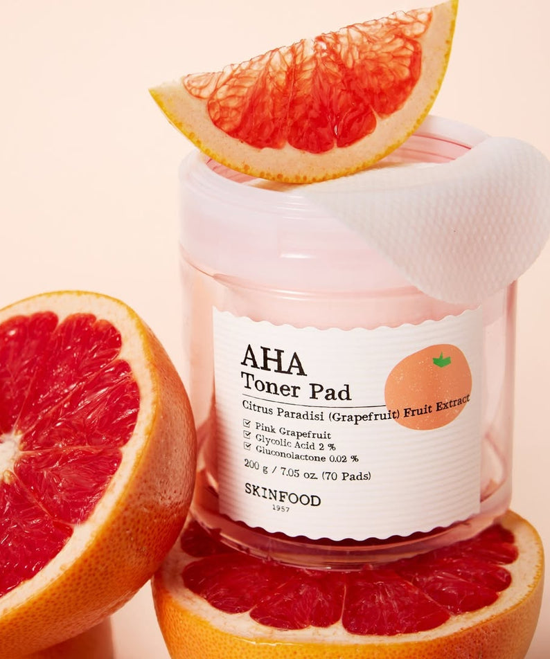 SKINFOOD Pink Grapefruit AHA Toner Pad 70 sheets displayed with fresh grapefruit slices