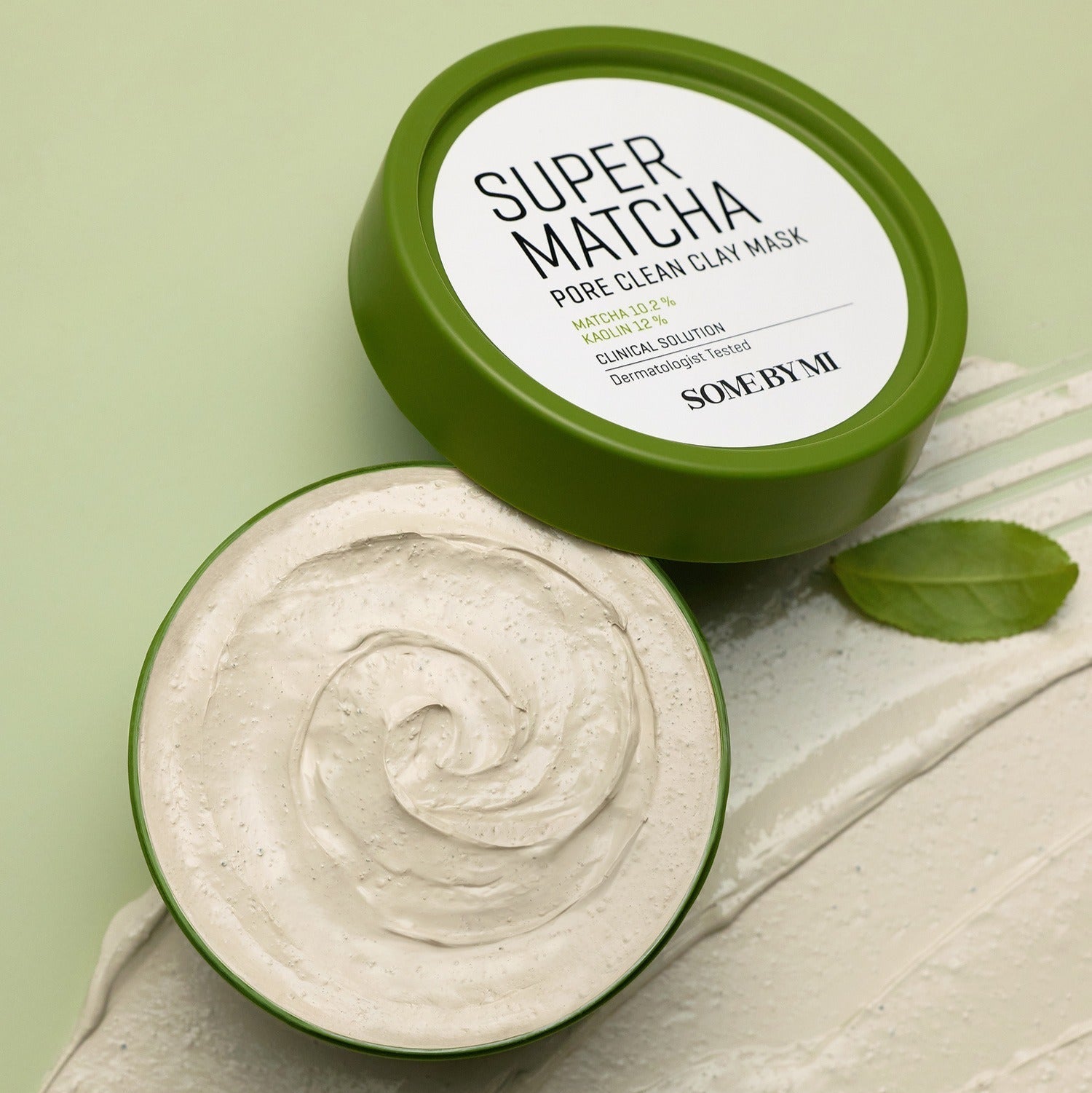 SOME BY MI Super Matcha Pore Clean Clay Mask 100g shown with open lid displaying creamy texture on a green background.