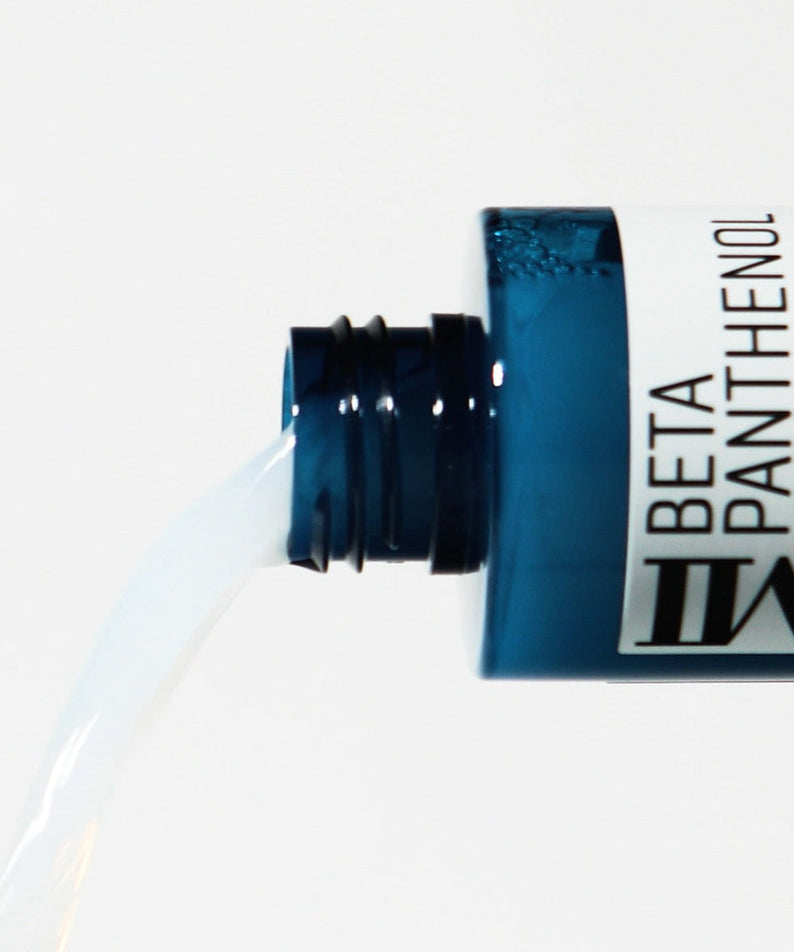 SOME BY MI Beta Panthenol Repair Toner 150ml spilling from blue bottle, close-up of product in action for skincare routine.