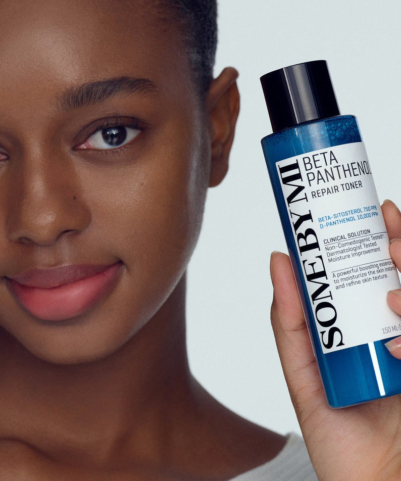 Woman holding SOME BY MI Beta Panthenol Repair Toner 150ml, showcasing skincare product.