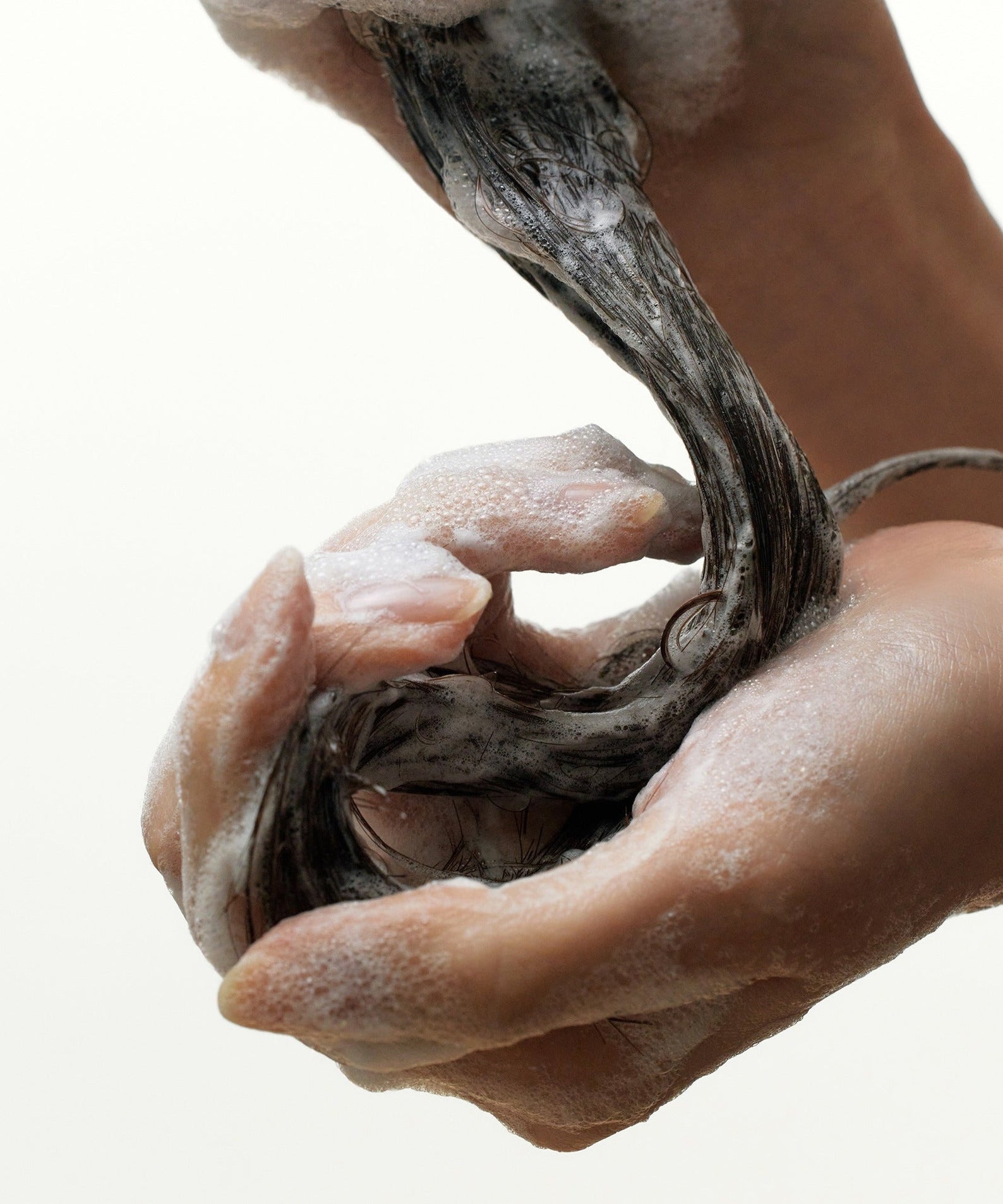 Hands applying SOME BY MI Cica Peptide Anti Hair Loos Derma Scalp Shampoo 285ml to wet hair, creating a foamy lather.