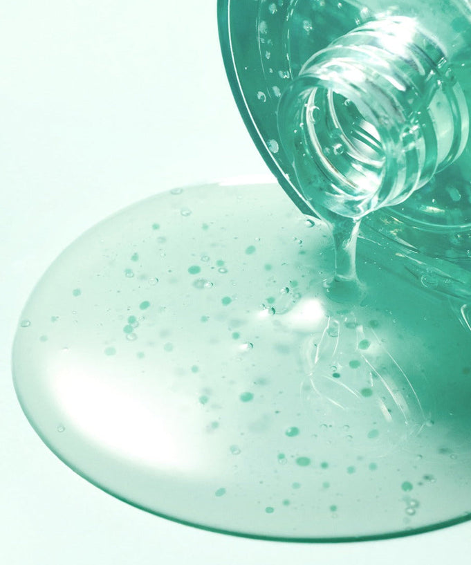 SOME BY MI PDRN Spirulina Soothing Repair Serum 50ml spilling from bottle, showcasing texture and color.