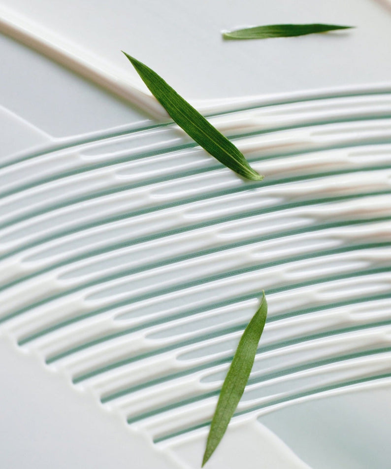 SOME BY MI Truecica Aqua Calming Sun Cream 50ml texture with green leaf accents