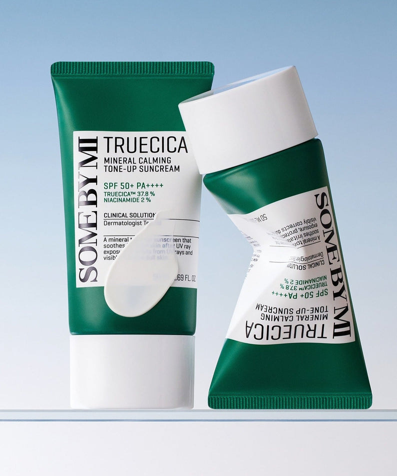 SOME BY MI Truecica Weaponless Calming Tone Up Sun Cream 50ml - green and white tubes displayed against a blue background