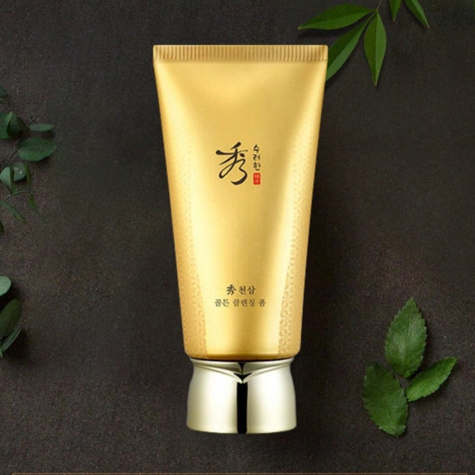 SOORYEHAN Cheonsam Golden Cleansing Foam 160ml with elegant gold packaging surrounded by leaves on a dark background