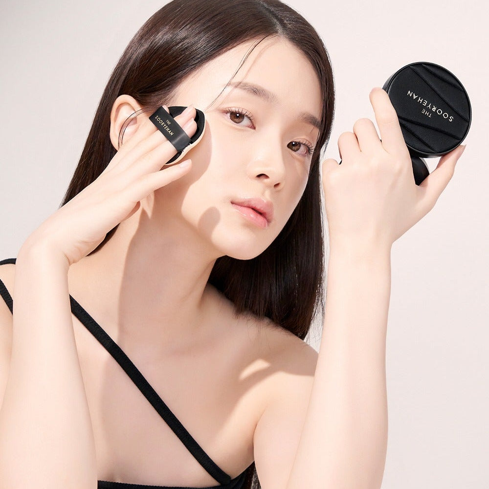 Woman applying SOORYEHAN The Black Tension Fit Mesh Cushion 13g for flawless skin.