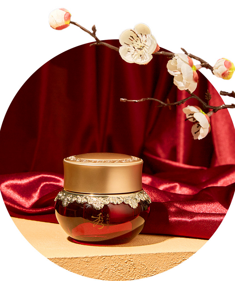 SOORYEHAN Hyobidam Fermented Eye Cream 25ml jar on red satin with cherry blossoms in background.