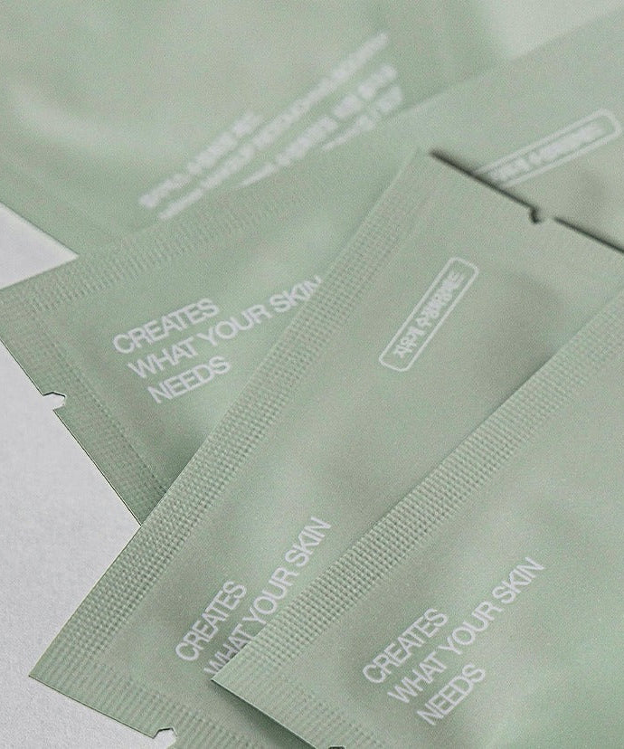 Close-up of CELIMAX 30 Corrective Makeup Pads packaging showing the text 'CREATES WHAT YOUR SKIN NEEDS' on green packets.