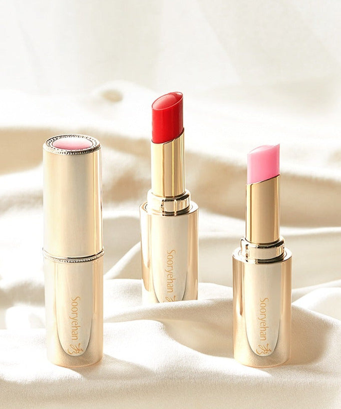 SOORYEHAN Yeon Silk Lip Balm 3.5g in elegant gold casing on a soft fabric background.