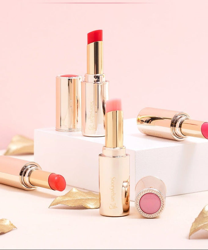 SOORYEHAN Yeon Silk Lip Balm 3.5g displayed elegantly with gold accents on a pink backdrop