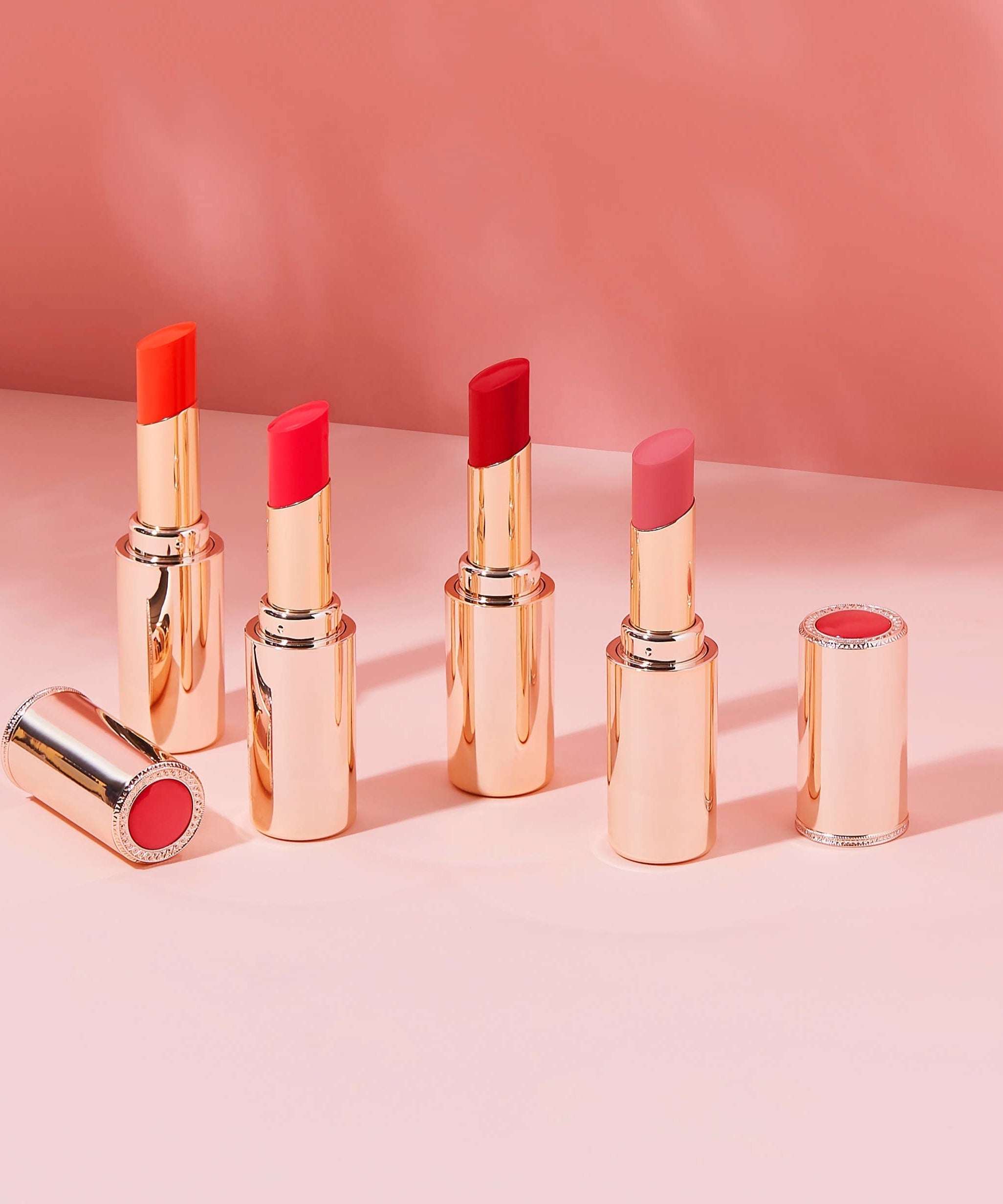 Four shades of SOORYEHAN Yeon Silk Lip Rough 3.5g lipsticks against a pink backdrop.