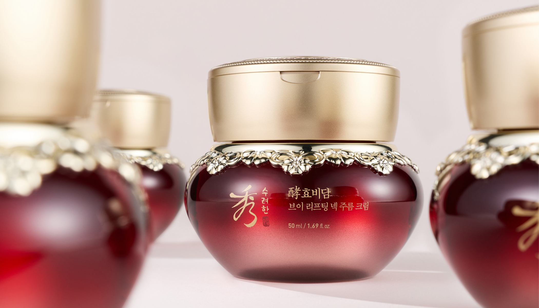 Luxurious red and gold face cream jar with elegant floral details, highlighting premium skincare