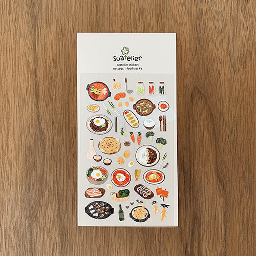 SUATELIER Food Trip #2 Stickers on wooden surface showcasing various food illustrations.