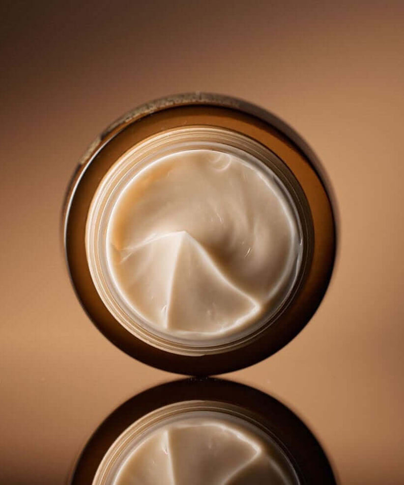 Open jar of SU:M37 Fermentalift Rejuvenating Eye Cream 25ml showcasing rich, creamy texture ideal for anti-aging skincare.