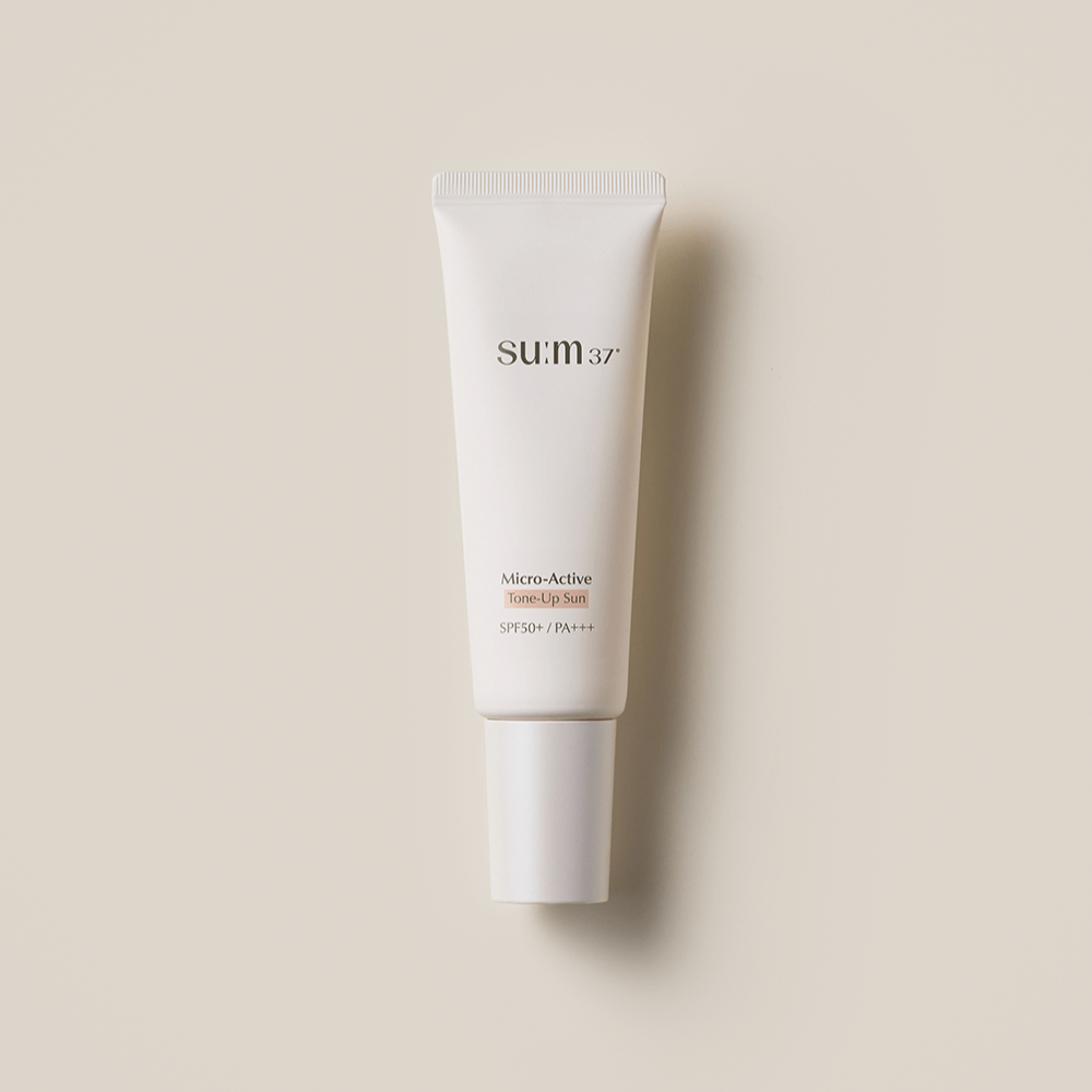 SU:M37 Microactive Tone Up Sun 50 SPF50+ / PA+++ sunscreen tube on beige background