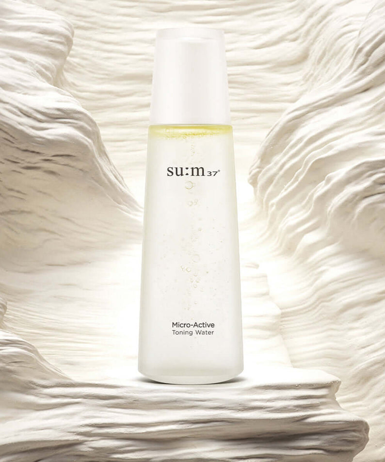 Image of SU:M37 Microactive Toning Water 150ml bottle against a textured background.
