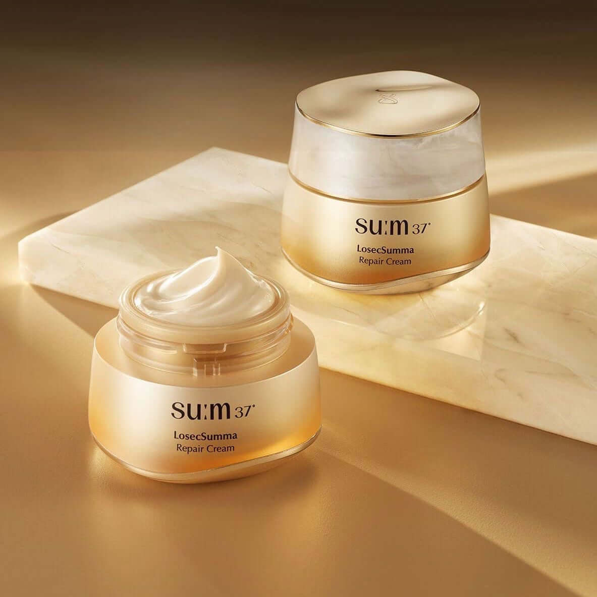 SU:M37 Rosicsumma Repair Cream 50ml displayed elegantly on a marble surface