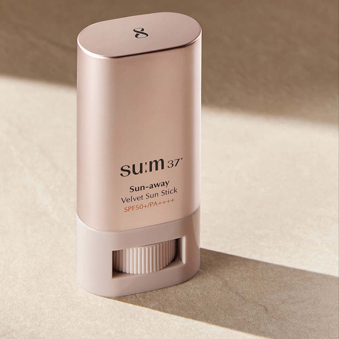 SU:M37 Sun-Away Velvet Sun Stick 18g on a neutral background.