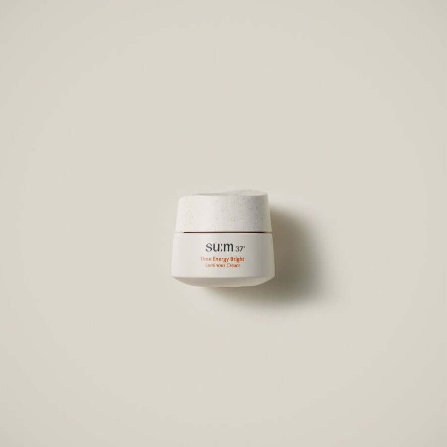SU:M37 Time Energy Bright Luminous Cream 50ml in an elegant white jar against a neutral background.