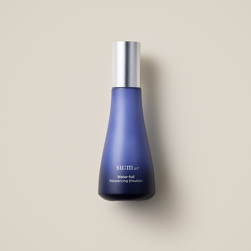 SU:M37 Water-full rebalancing emulsion 120ml in a sleek blue bottle with a silver cap on a neutral background