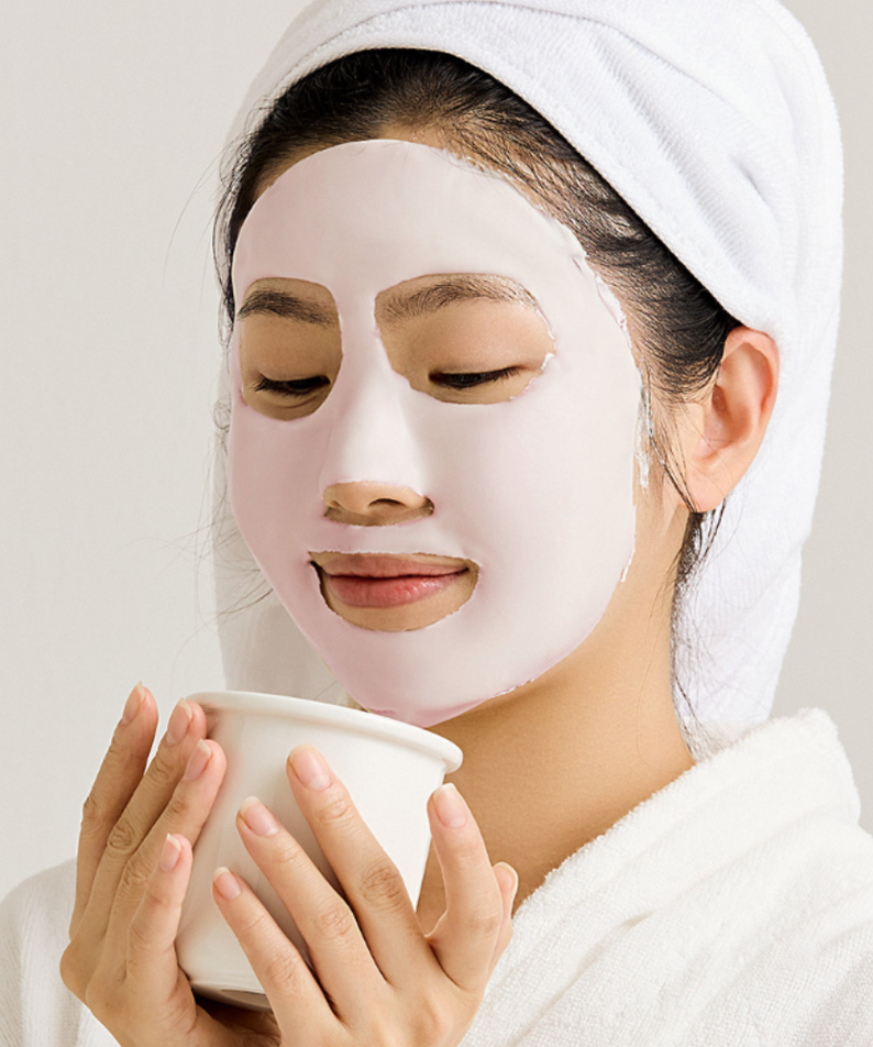 Woman applying SUNGBOON EDITOR Boosting Modeling Pack Apple Peel Glow Soothing for skincare routine