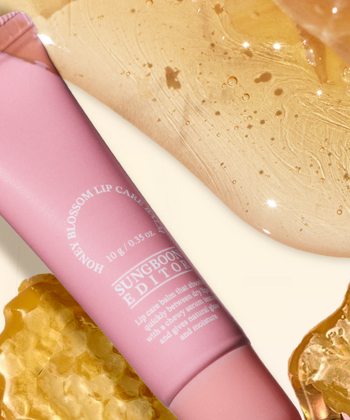 SUNGBOON EDITOR Honey Blossom Lip Care Balm in pink packaging with honey texture background, enhancing lip care and moisture.