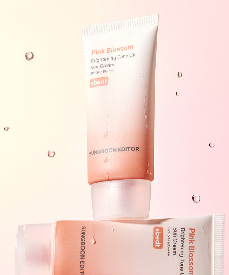 SUNGBOON EDITOR Pink Blossom Brightening Tone-Up Sunscream 50ml displayed with soft pink background and water droplets.
