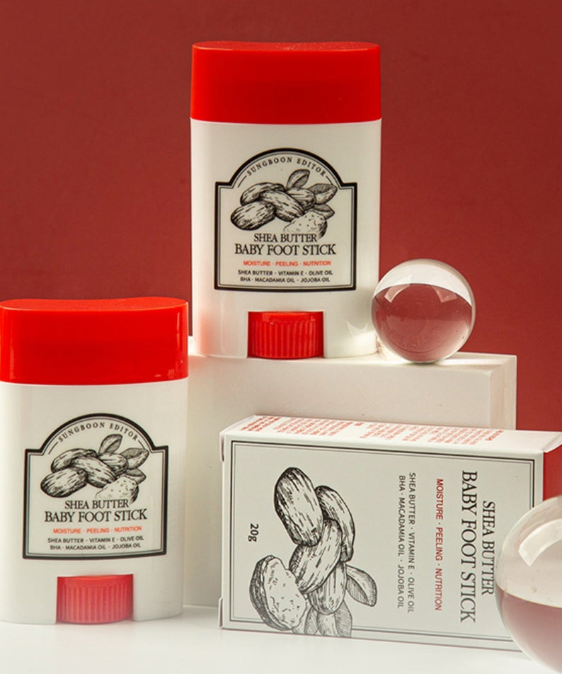 SUNGBOON EDITOR Shea Butter Baby Foot Stick displayed with packaging and decorative elements.